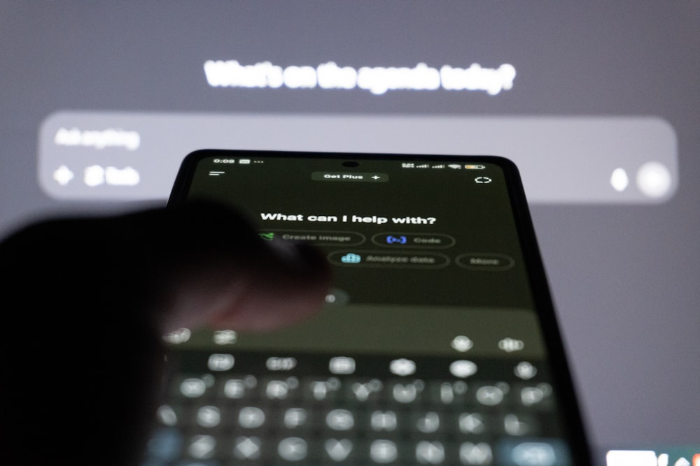 Person typing on smartphone with AI chatbot